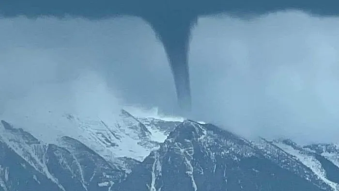 A landspout tornado forming with snow on the ground. This is not related to the phenomenon discussed, as this is not a true supercell tornado.